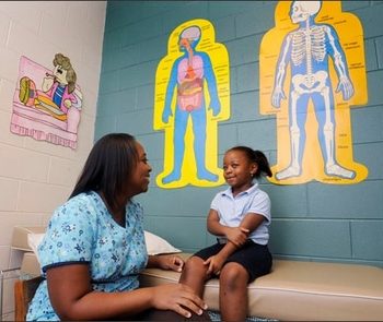 School nurse Tomicka Barnes R.N. talks with kindergarden pupil Tamiyah Dubose at T.S. Morris Elementary School in Montgomery, Ala. on Friday September 18, 2009.(AP Photo/Montgomery Advertiser, Mickey Welsh)